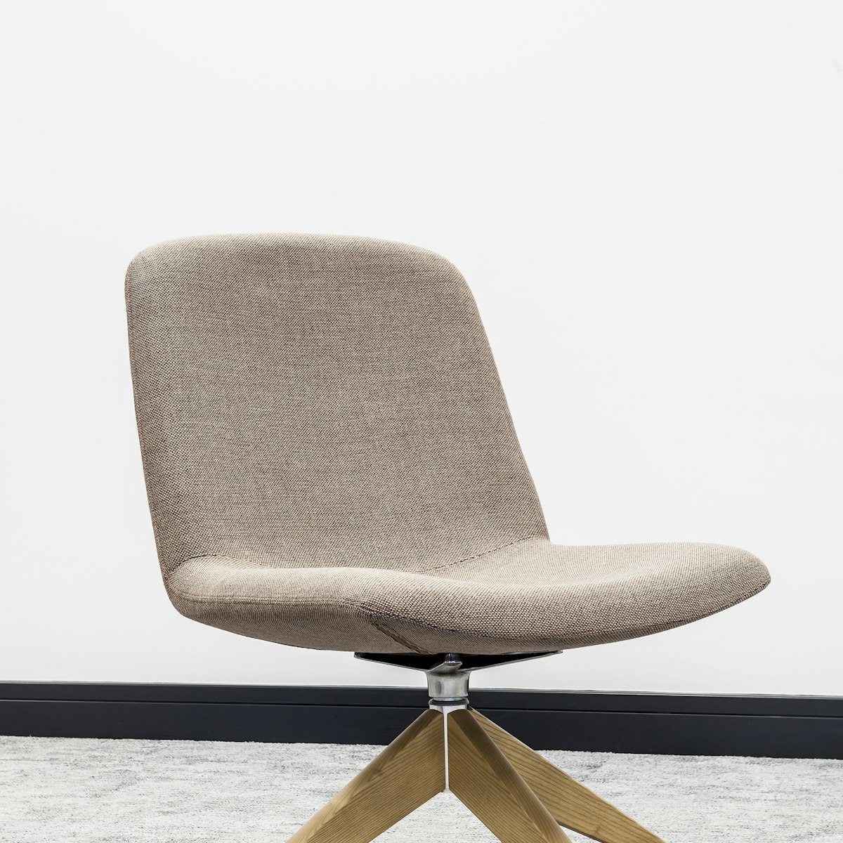 Taupe swivel lounge chair on a four-star oak base